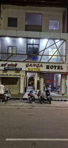 two motorcycles parked in front of a store at Hotel ganga in Ajmer