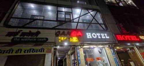 a building with neon signs on it at night at Hotel ganga in Ajmer