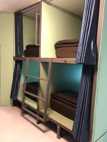 a room with three shelves with brown towels at The City Hostel in Phi Phi Don