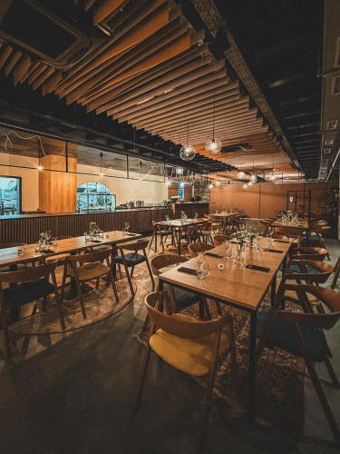 a dining room with wooden tables and chairs at Hotel Campus 90 - Free Parking in Varna City