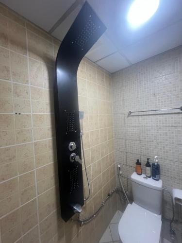 a shower in a bathroom with a toilet at AlNahda Border SHJ-DXB- 2BADROOM AND HALL FULL FLAT FOR YOU ONLY in Sharjah