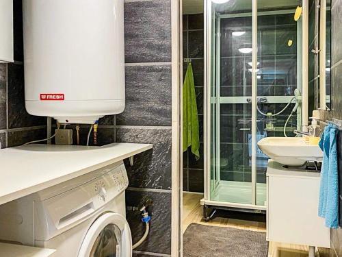 a bathroom with a washing machine and a sink at 6 person holiday home in FIGEHOLM-By Traum in Figeholm