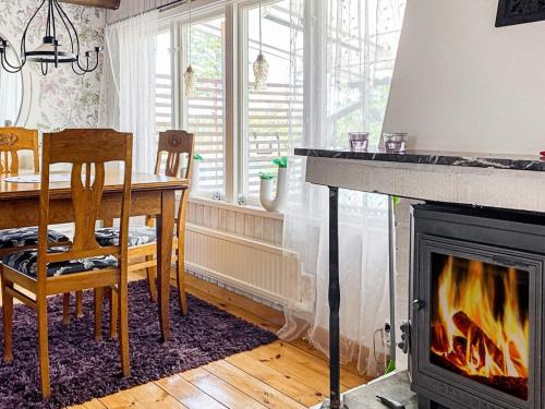 a living room with a table and a fireplace at 6 person holiday home in FIGEHOLM-By Traum in Figeholm
