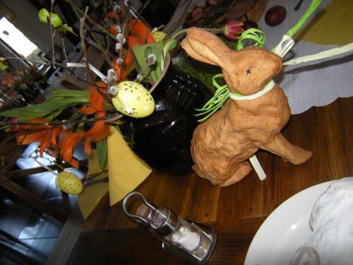 a stuffed rabbit sitting on a table next to a vase at Dwa Dęby in Lubawka