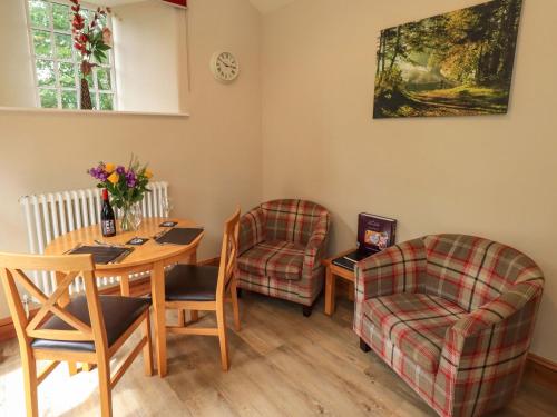 a dining room with a table and two chairs and a table and a chair at Abbots Reading Suite in Lake Side