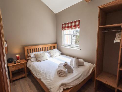 a bedroom with a bed with towels on it at Abbots Reading Suite in Lake Side