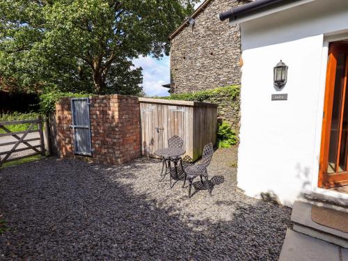two chairs and a fence next to a house at Abbots Reading Suite in Lake Side