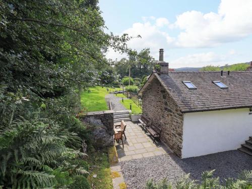 an external view of a stone house with a patio at Abbots Reading Mews 1 in Lake Side