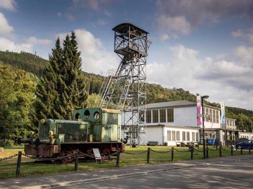 an old train on display in front of a building at Holiday home in Ramsbeck with garden in Ramsbeck