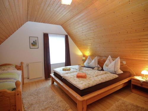 a bedroom with a bed in a wooden room at Holiday home in Ramsbeck with garden in Ramsbeck