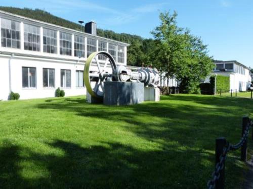 a sculpture in the grass in front of a building at Holiday home in Ramsbeck with garden in Ramsbeck