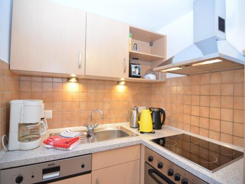 a kitchen with a sink and a microwave at Holiday home in Ramsbeck with garden in Ramsbeck