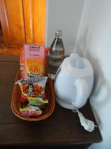 a tray with a bowl of food and a bottle of water at Baiyoke Chalet Hotel in Mae Hong Son