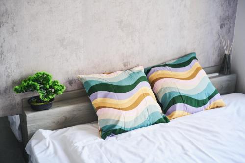 a bed with two pillows and a plant on it at Cyber Shinjyuku Tokyo Room in Tokyo