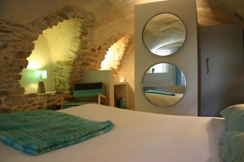 a bedroom with a bed and a mirror at Chambre d'hôtes La Font in Eygliers