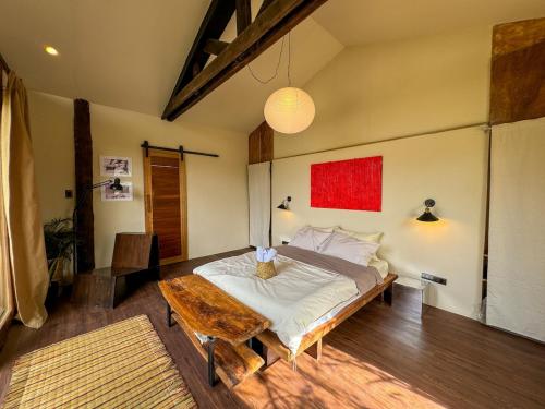 a bedroom with a bed and a wooden table at Kismet House Central & Private Cozy Home in General Luna in General Luna