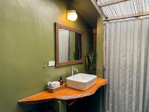a bathroom with a sink and a shower at Kismet House Central & Private Cozy Home in General Luna in General Luna