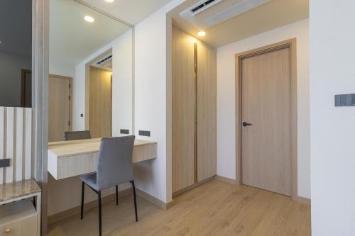 a room with a desk and a chair and a mirror at C227 Brand New Condo Near Top Phuket Beach Clubs in Laguna Phuket