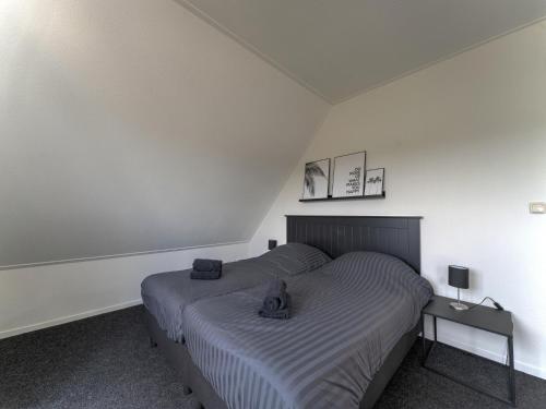 a bedroom with a bed with two towels on it at Villa in Zeewolde near Horsterwold Forest in Zeewolde
