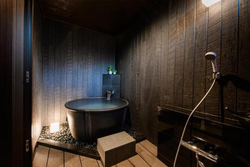 a bathroom with a bath tub and a shower at Hana-No-Mizuumi Hotel in Hakone