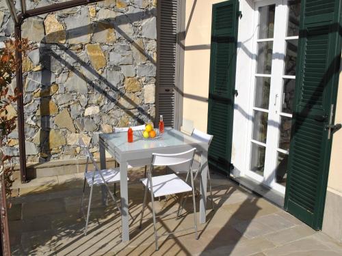 a white table and chairs on a patio at Apartment Finale Ligure near Ondina Beach in Magliolo