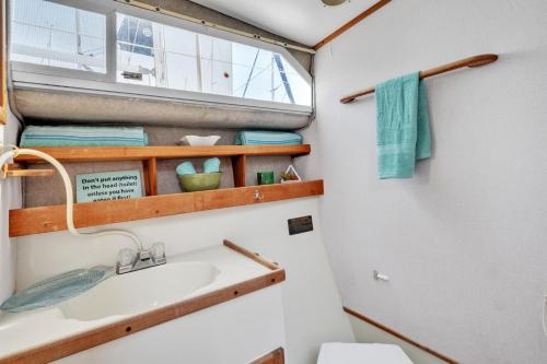 a bathroom with a sink and a window at Luxury 2BR Yacht • Marina Views • WiFi in Anacortes