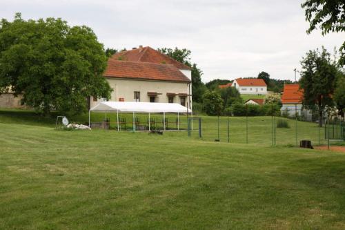a building with a tent in the middle of a field at Penzion Haberský vrch in Habří