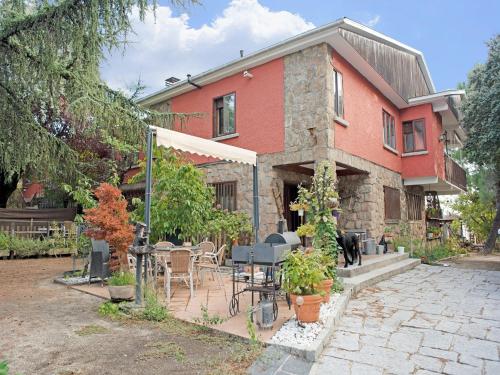 a house with a table and chairs in front of it at Flat in Galapagar with Spa and Mountain Views in Galapagar