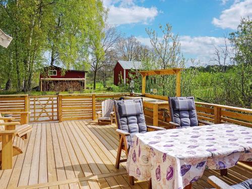 a wooden deck with a table and chairs on it at Serene Seaside Retreat in Adelso-By Traum in Adelsö
