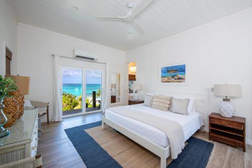 a bedroom with a bed and a view of the ocean at Azure home in Palmetto Point