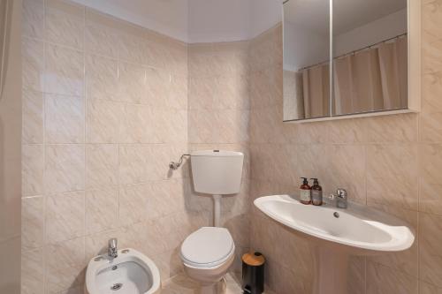 a bathroom with a toilet and a sink at Blue House Burgau in Burgau