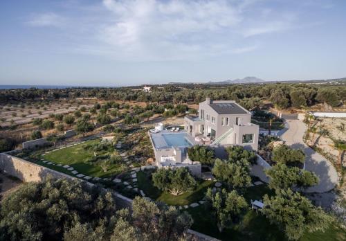 an aerial view of a large white house at White Grace - A Seductive World of Luxury in Pigi