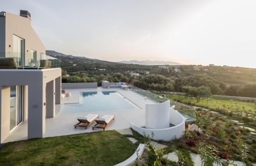 a view of a villa with a swimming pool at White Grace - A Seductive World of Luxury in Pigi