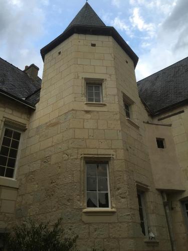 a brick building with a tower on top of it at Au Relais Saint Maurice in Chinon