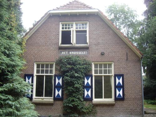 a red brick house with blue and white decorations on it at Holiday Home in Zelhem with Garden in Zelhem
