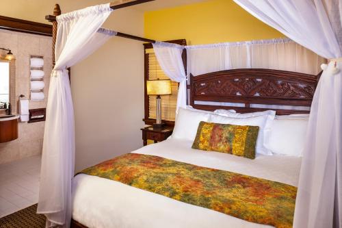 a bedroom with a bed with a canopy at Pantai Inn in San Diego
