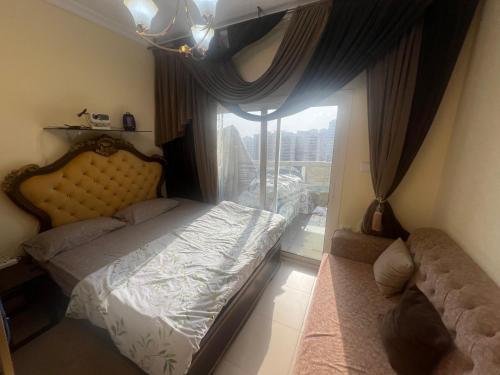 a small bedroom with a bed and a window at AlNahda Border SHJ-DXB -ZAMAZM GuestHouse in Sharjah