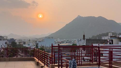 a view of a city with a mountain in the background at Hotel Times Stay in Udaipur