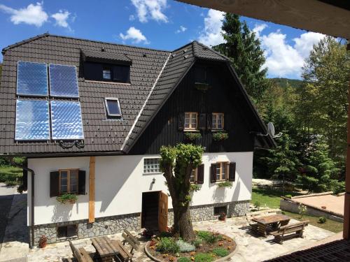 a house with solar panels on the roof at Rustic Inn River 2 in Plitvička Jezera