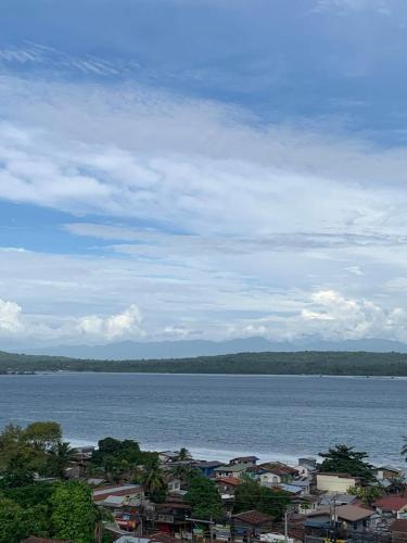 a view of a large body of water with houses at Seawind Condominium Near Airport in Davao City