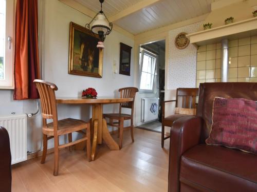 a living room with a wooden table and chairs at Holiday home in with cycling area in Den Ham
