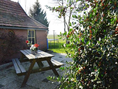 a picnic table with flowers on it in a garden at Holiday home in with cycling area in Den Ham