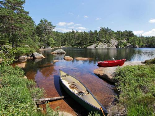 two boats sitting on the shore of a lake at 8 person holiday home in Kvås in Kvås
