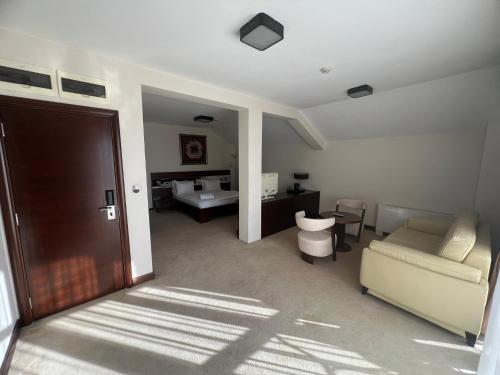 a living room with a couch and a bed at Hotel Aria in Podgorica
