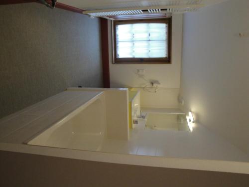 a large bath tub in a bathroom with a window at Nettancourt Family Stay in Revigny-sur-Ornain