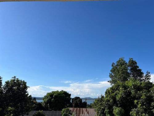 a group of trees with a blue sky in the background at Hotel Royal Nest Entebbe in Entebbe