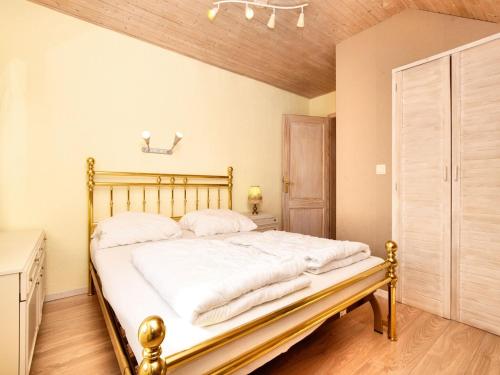 a bedroom with a large bed with white sheets at Holiday Home in Schצnberg with Jacuzzi in Schoenberg