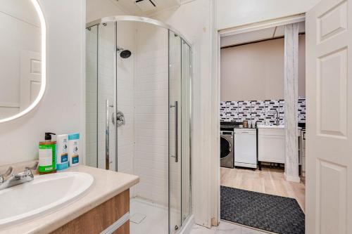 a bathroom with a shower and a sink at Great 1BR Apartment near VIA Rail in London