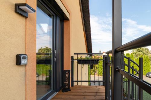 a sliding glass door to a balcony with a view at TinyGreens B & B in Poděbrady