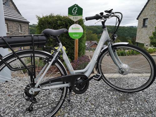 a bike parked in front of a sign at Luxurious Cottage in Aywaille with Sauna in Aywaille